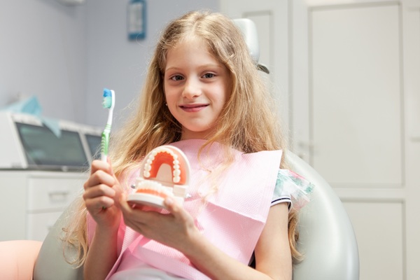 Should I Take My Child To A Kid Friendly Dentist In Merrick For White Spots On Teeth?